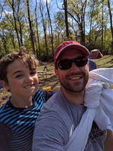 Liam riding on Mark's back as they went for a hike with his cub scout troop.